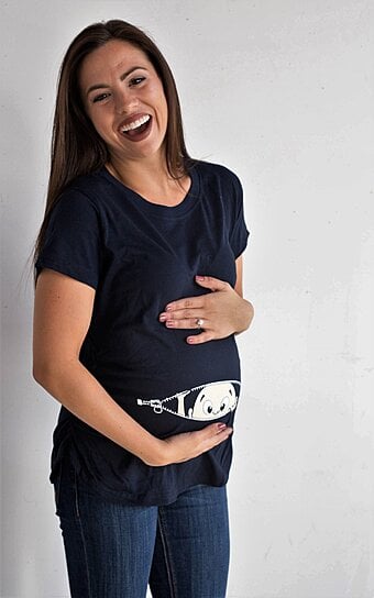 baby peeking out of belly shirt